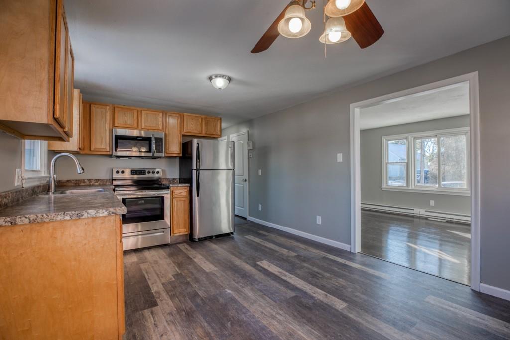 173 Lucerne Road Springfield, MA 01119 - Photo 4 of 22 a kitchen with stainless steel appliances granite countertop a refrigerator a stove top oven a sink and dishwasher