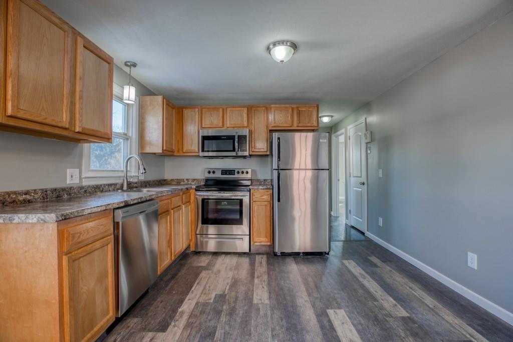 173 Lucerne Road Springfield, MA 01119 - Photo 5 of 22 a kitchen with granite countertop a refrigerator stove and microwave