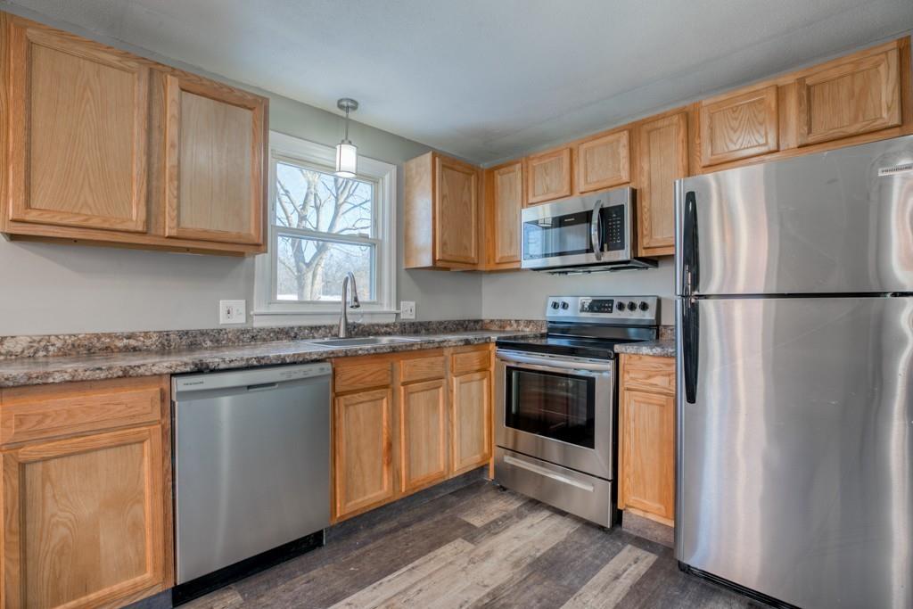 173 Lucerne Road Springfield, MA 01119 - Photo 6 of 22 a kitchen with granite countertop a refrigerator stove top oven and sink