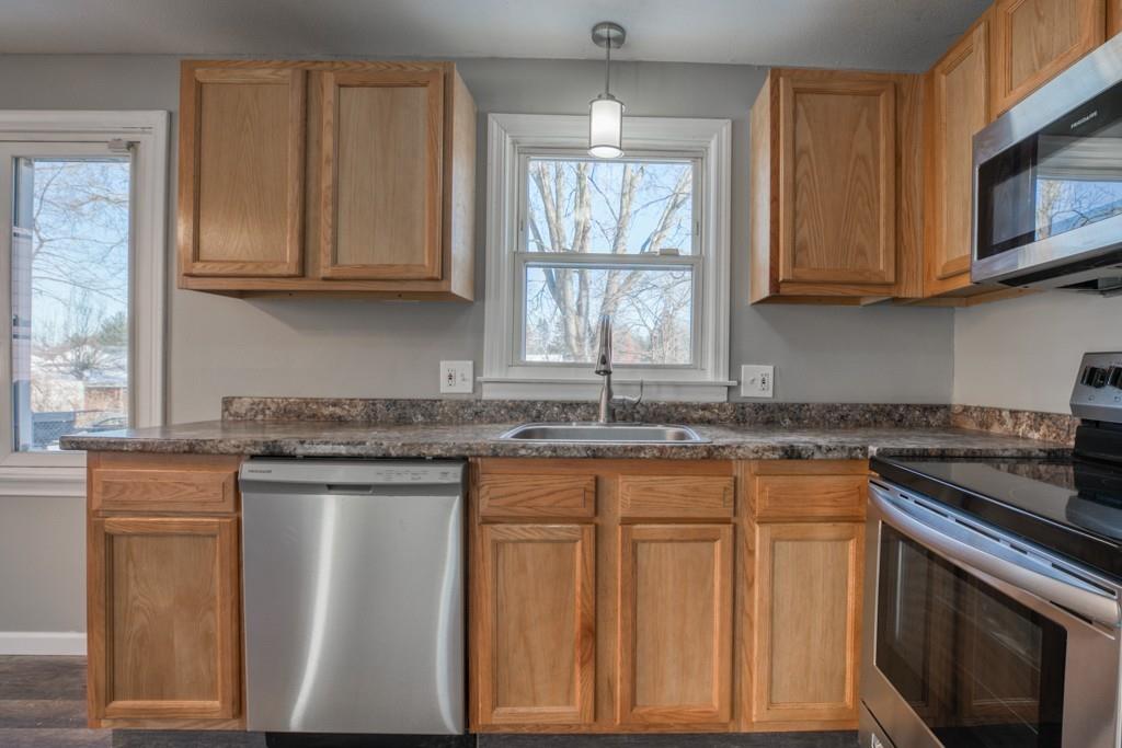 173 Lucerne Road Springfield, MA 01119 - Photo 7 of 22 a kitchen with stainless steel appliances granite countertop a stove a sink and a microwave