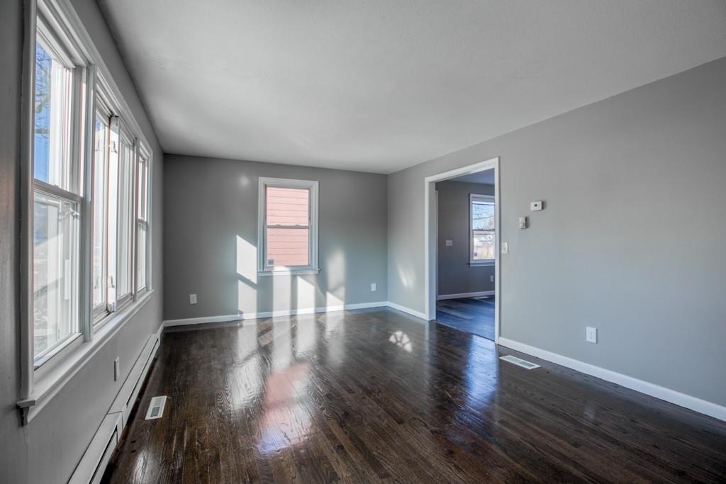 173 Lucerne Road Springfield, MA 01119 - Photo 9 of 22 a view of an empty room with wooden floor and a window