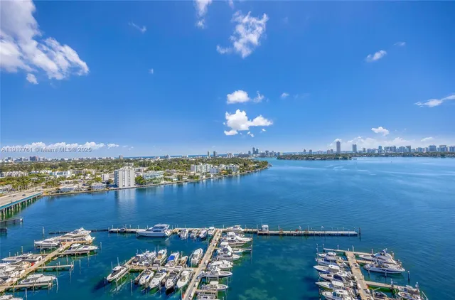 a view of a lake with couches chairs