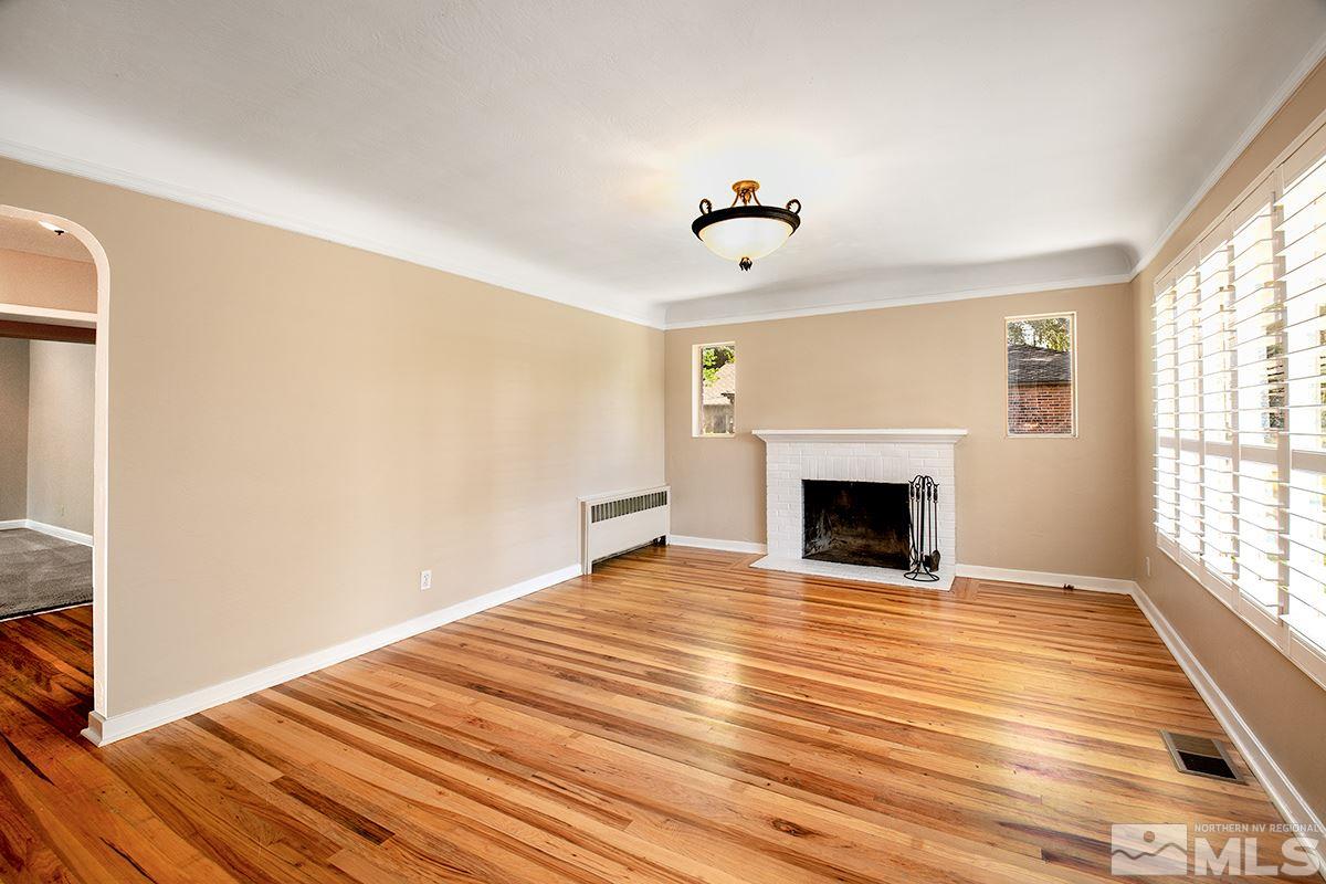 825 Daniel Drive Reno, NV 89509 - Photo 4 of 25 a view of empty room with fireplace and wooden floor