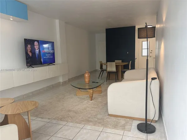 a living room with couches and a flat screen tv