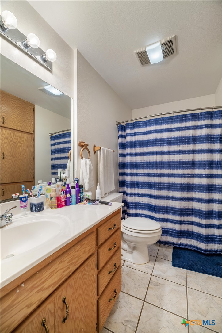 374-376 Navidad Street Vanderbilt, TX 77991 - Photo 12 of 28 a bathroom with a sink a toilet and shower