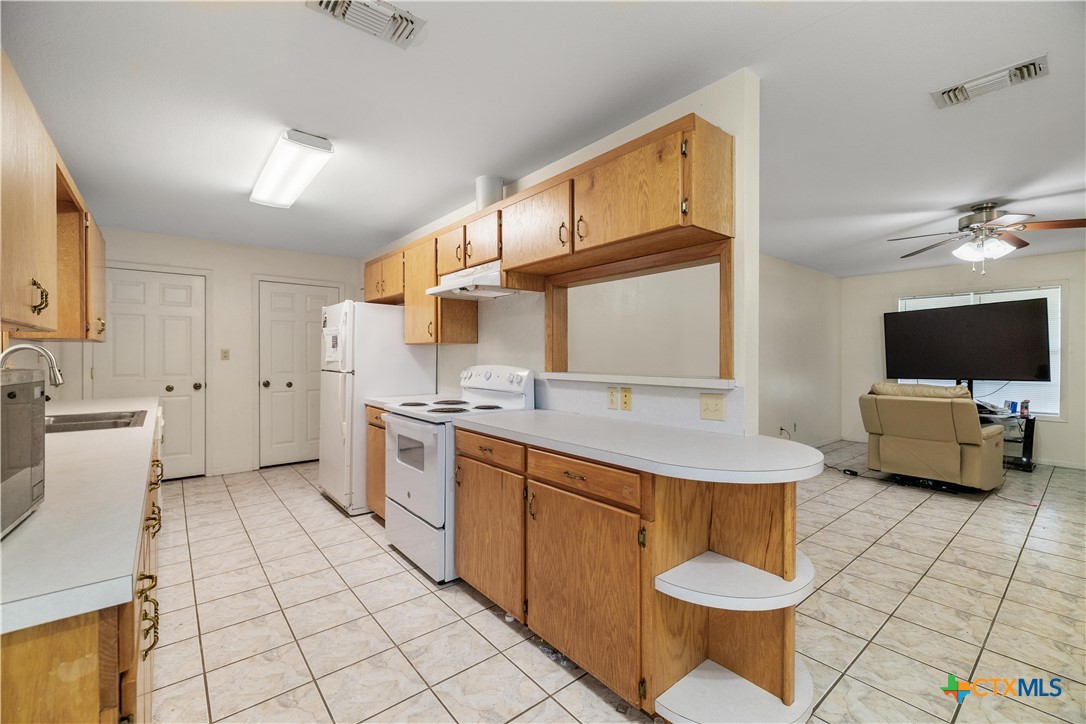 374-376 Navidad Street Vanderbilt, TX 77991 - Photo 20 of 28 a kitchen with a sink and a stove top oven