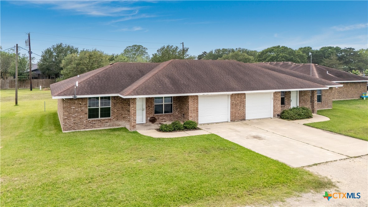 374-376 Navidad Street Vanderbilt, TX 77991 - Photo 2 of 28 a white house covered with tall trees