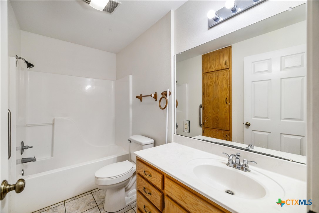 374-376 Navidad Street Vanderbilt, TX 77991 - Photo 21 of 28 a bathroom with a sink a toilet and shower