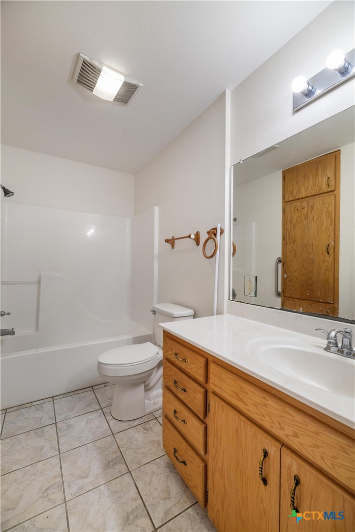374-376 Navidad Street Vanderbilt, TX 77991 - Photo 22 of 28 a bathroom with a sink a toilet and shower