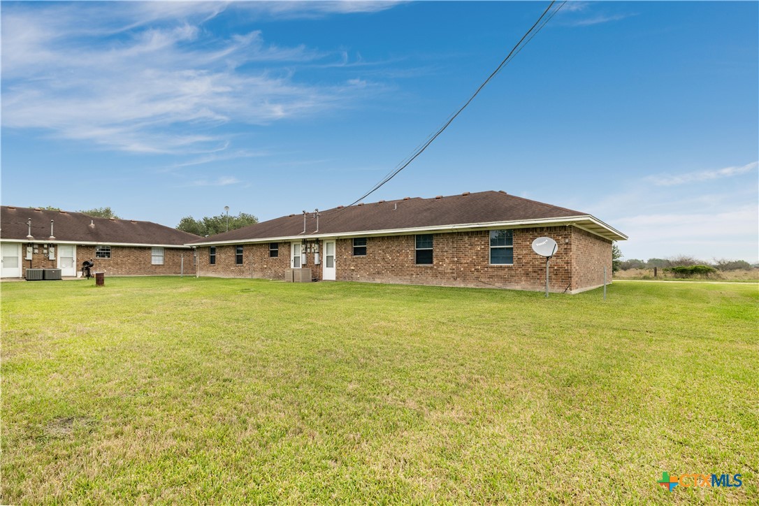 374-376 Navidad Street Vanderbilt, TX 77991 - Photo 26 of 28 a front view of a house with a big yard