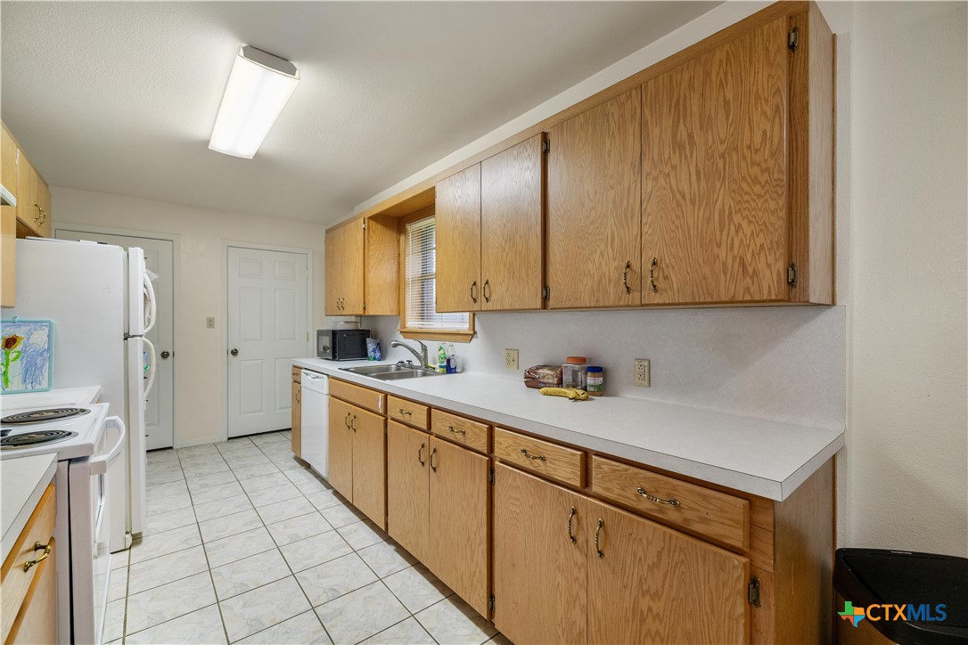 374-376 Navidad Street Vanderbilt, TX 77991 - Photo 7 of 28 a kitchen with a cabinets window and appliances