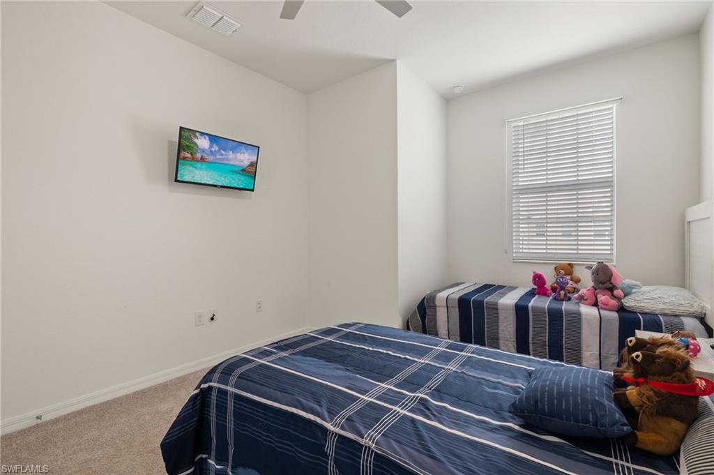 2934 Citrus Street Naples, FL 34120 - Photo 15 of 29 a bedroom with a bed and a dresser