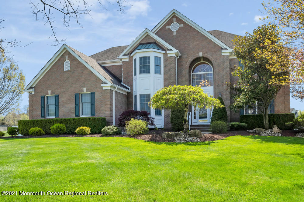30 Red Oak Lane Freehold, NJ 07728 - Photo 1 of 73 a front view of a house with a yard and potted plants