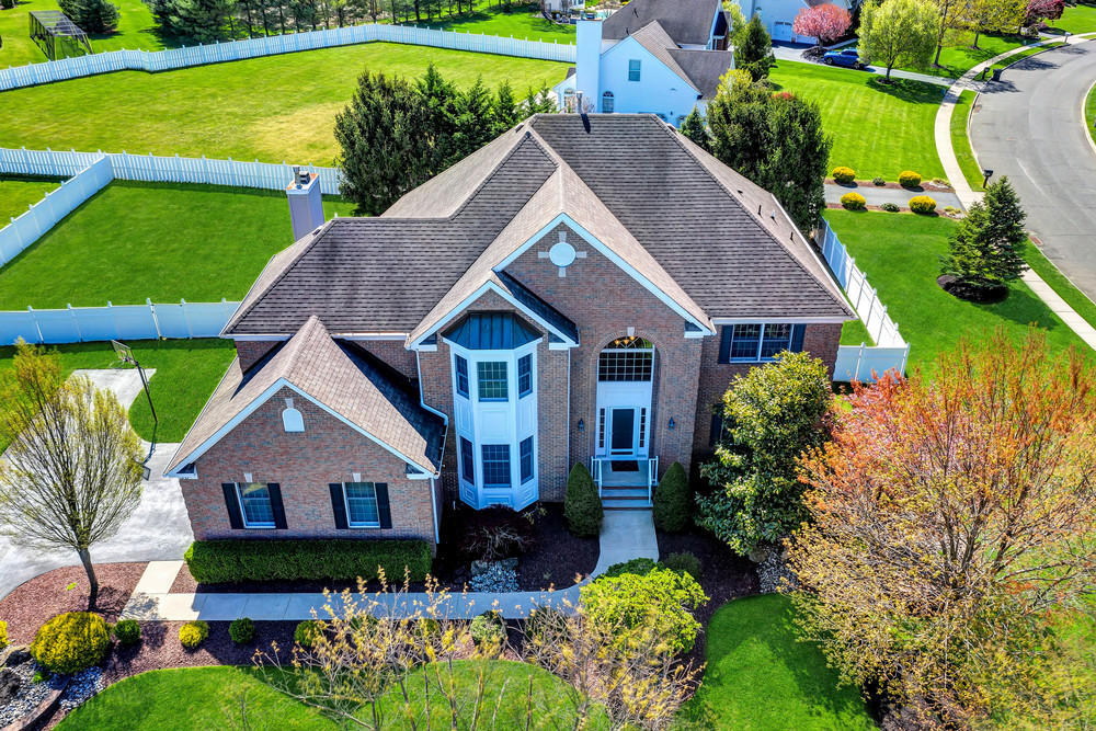 30 Red Oak Lane Freehold, NJ 07728 - Photo 2 of 73 a aerial view of a house with a yard and potted plants