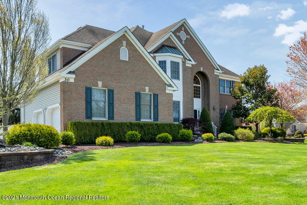 30 Red Oak Lane Freehold, NJ 07728 - Photo 3 of 73 a front view of a house with a yard