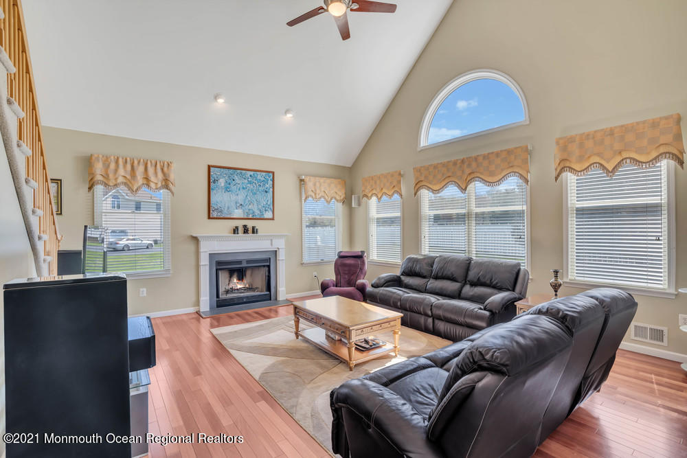 30 Red Oak Lane Freehold, NJ 07728 - Photo 30 of 73 a living room with furniture a fireplace and a large window