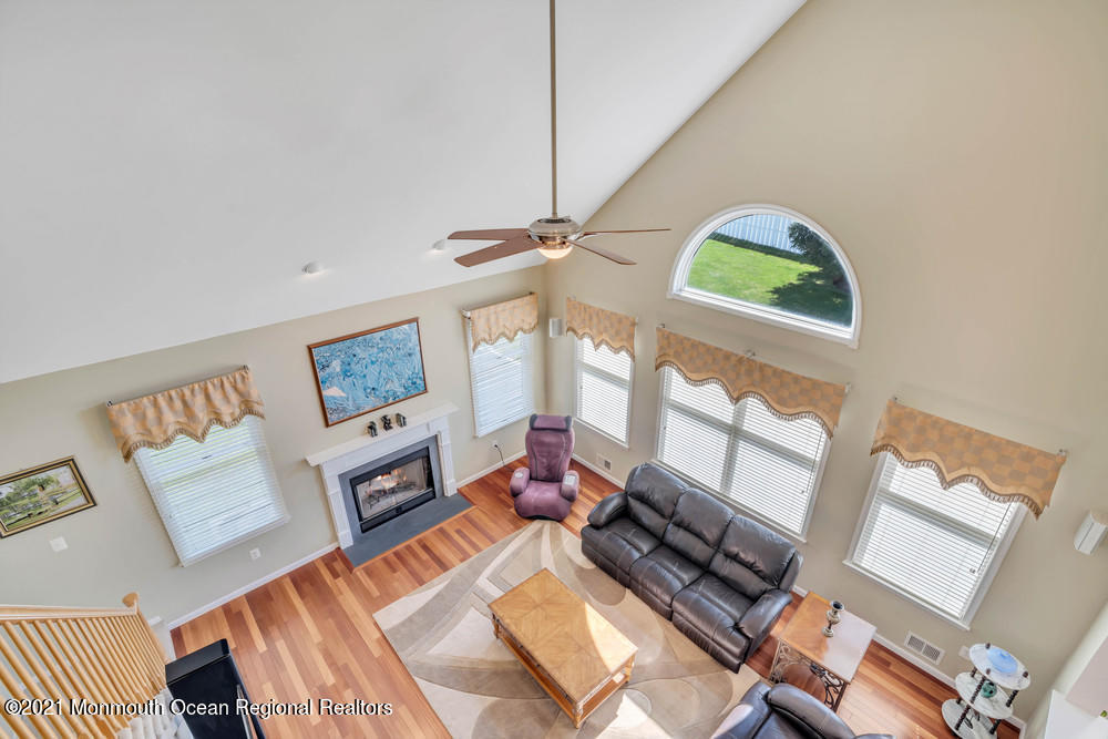 30 Red Oak Lane Freehold, NJ 07728 - Photo 33 of 73 a living room with furniture and a floor to ceiling window