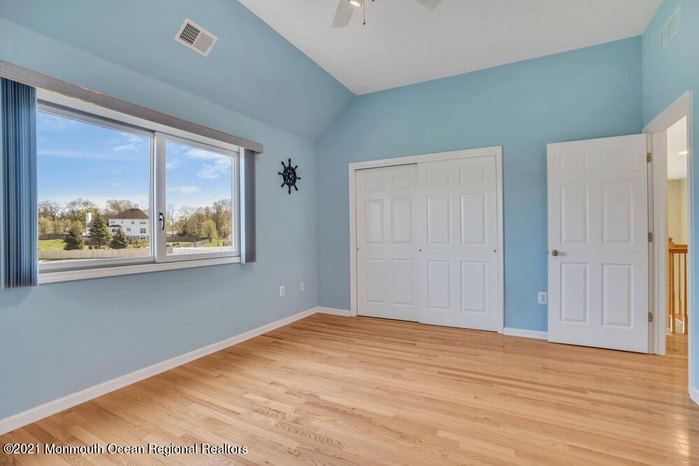 30 Red Oak Lane Freehold, NJ 07728 - Photo 35 of 73 a view of empty room with window and wooden floor