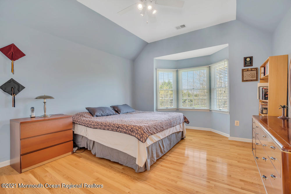 30 Red Oak Lane Freehold, NJ 07728 - Photo 41 of 73 a spacious bedroom with a bed and a dresser in it