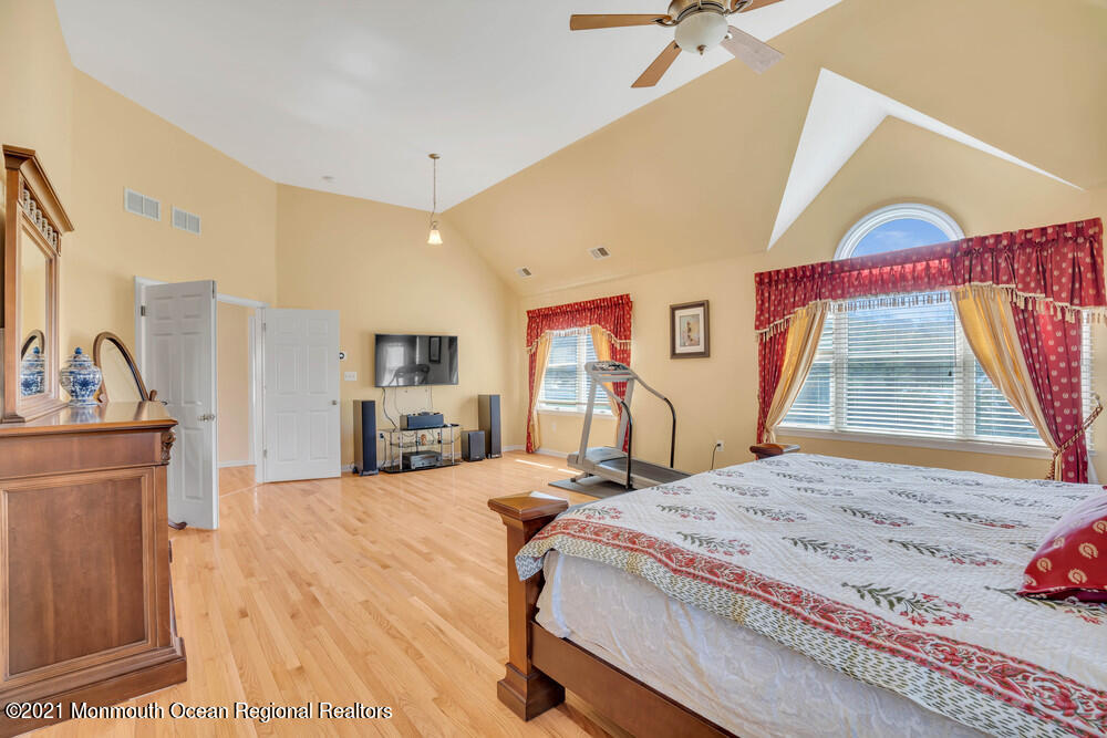 30 Red Oak Lane Freehold, NJ 07728 - Photo 49 of 73 a bedroom with a bed and a flat tv screen next to a window