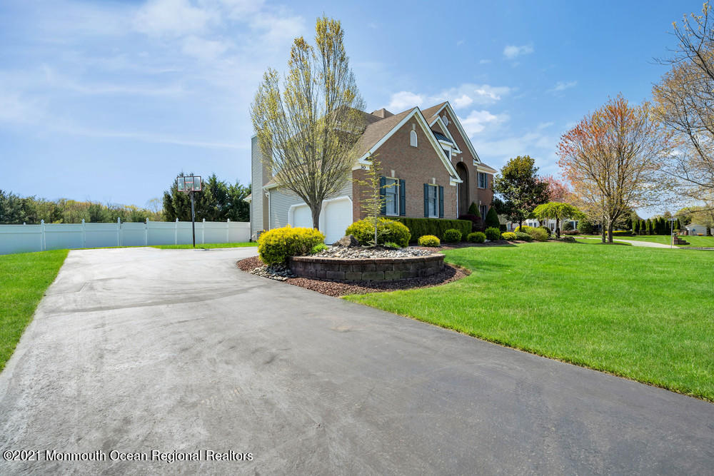 30 Red Oak Lane Freehold, NJ 07728 - Photo 6 of 73 a front view of a house with a yard and trees
