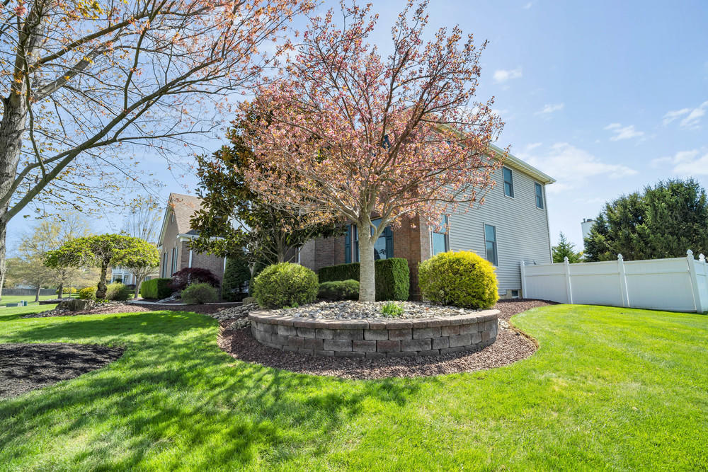 30 Red Oak Lane Freehold, NJ 07728 - Photo 8 of 73 a view of a house with a yard fire pit and a large tree