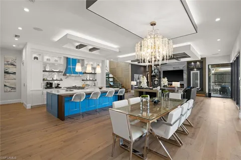 a view of a dining room kitchen and a chandelier