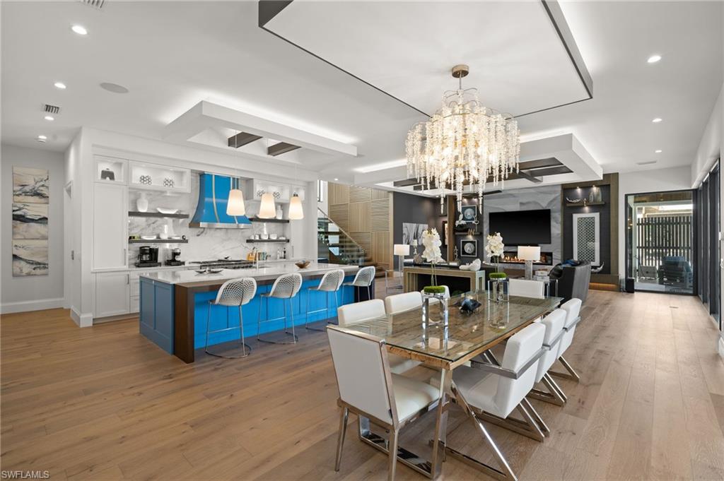 255 21st Avenue South Naples, FL 34102 - Photo 14 of 36 a view of a dining room kitchen and a chandelier