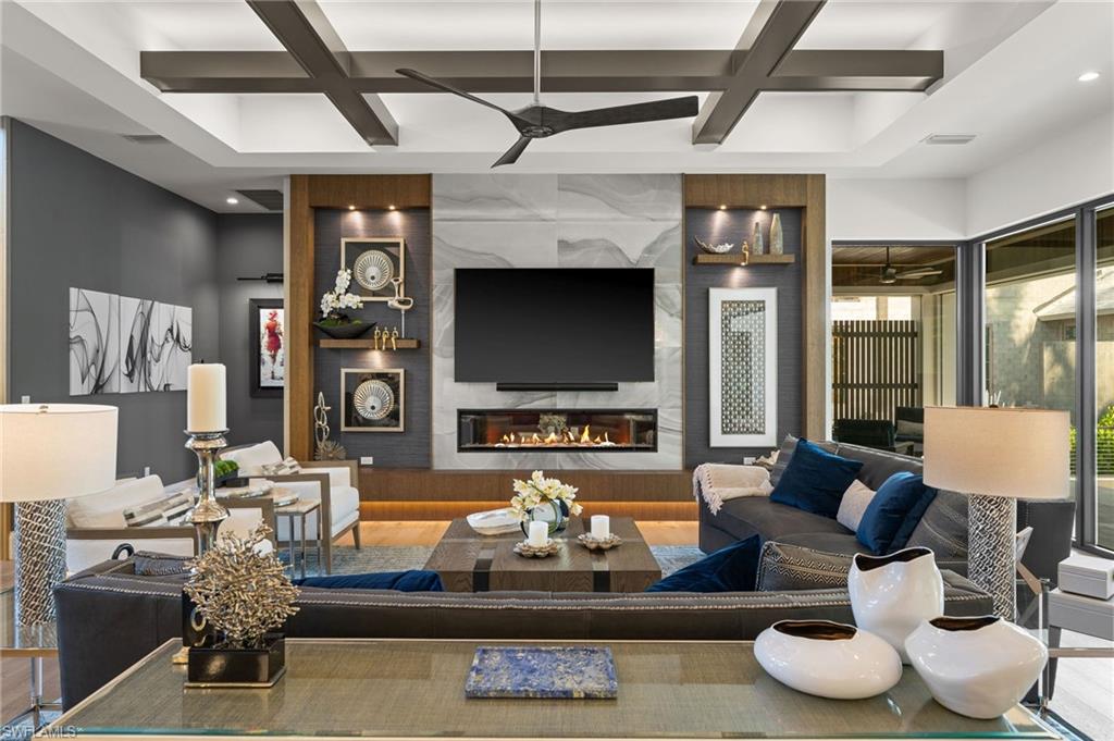 255 21st Avenue South Naples, FL 34102 - Photo 16 of 36 a living room with furniture and a flat screen tv