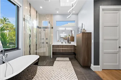 a bathroom with a double vanity sink a mirror and a shower