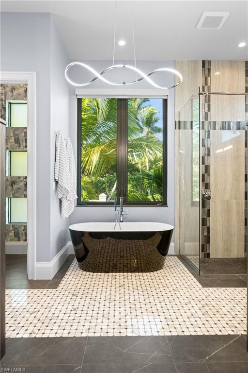 255 21st Avenue South Naples, FL 34102 - Photo 20 of 36 a bathroom with a bathtub and large window