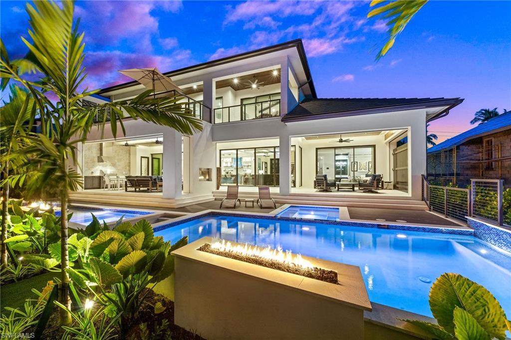 255 21st Avenue South Naples, FL 34102 - Photo 2 of 36 a view of a house with swimming pool and sitting area