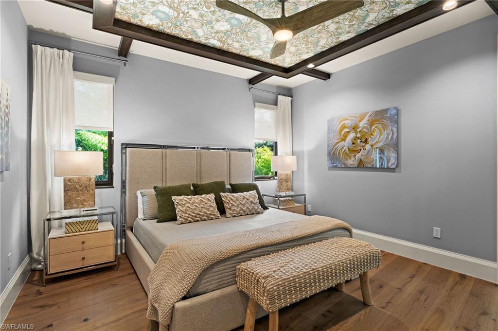 255 21st Avenue South Naples, FL 34102 - Photo 22 of 36 a bedroom with a bed and wooden floor