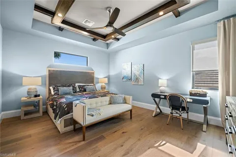 a bedroom with a bed window and a table