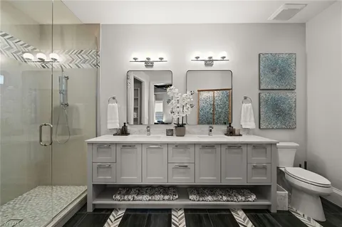 a bathroom with a sink toilet a mirror and shower