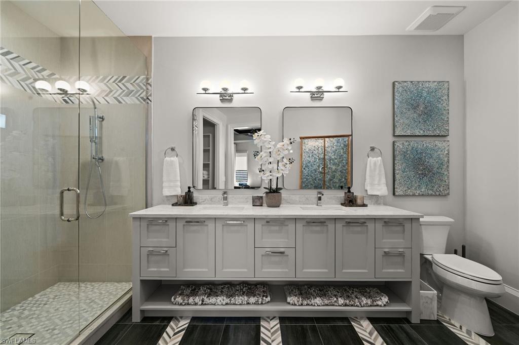 255 21st Avenue South Naples, FL 34102 - Photo 28 of 36 a bathroom with a sink toilet a mirror and shower