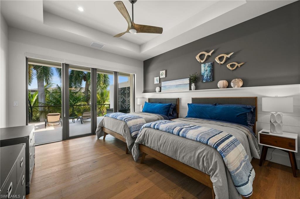 255 21st Avenue South Naples, FL 34102 - Photo 29 of 36 a spacious bedroom with a large bed and a large window