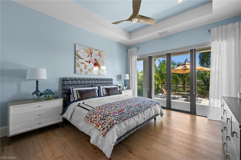 255 21st Avenue South Naples, FL 34102 - Photo 30 of 36 a bedroom with a large bed and a tv on table