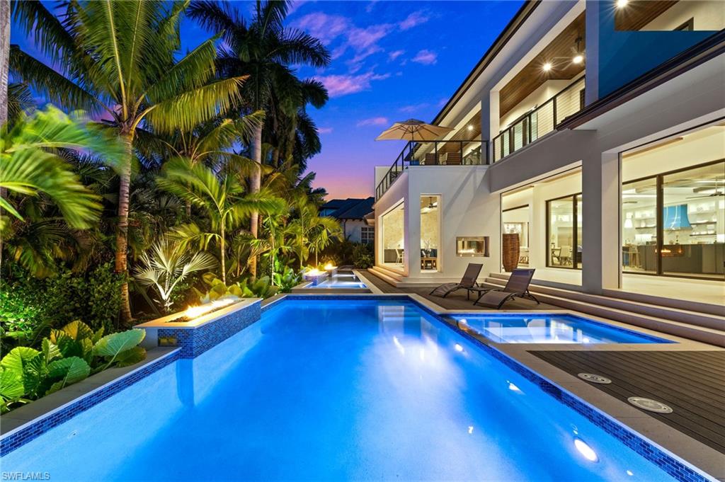 255 21st Avenue South Naples, FL 34102 - Photo 3 of 36 a view of swimming pool with outdoor seating and yard
