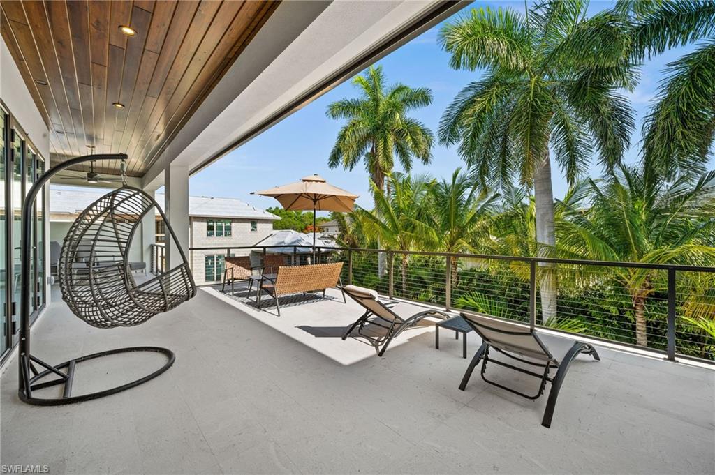 255 21st Avenue South Naples, FL 34102 - Photo 31 of 36 a building outdoor space with patio furniture and potted plants