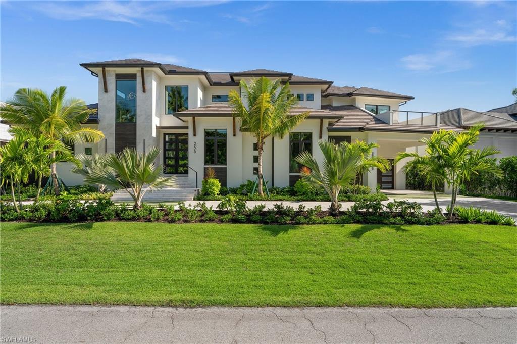 255 21st Avenue South Naples, FL 34102 - Photo 32 of 36 a front view of building with yard