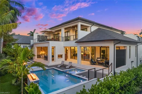 a front view of a house with swimming pool and porch