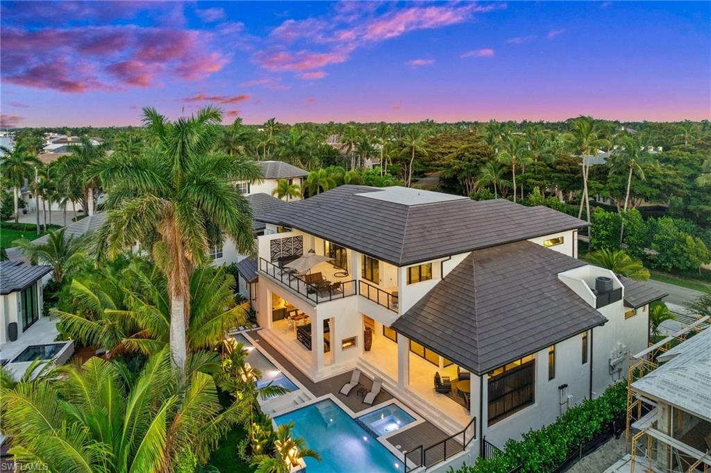 255 21st Avenue South Naples, FL 34102 - Photo 36 of 36 a view of a big house with a big yard plants and large trees
