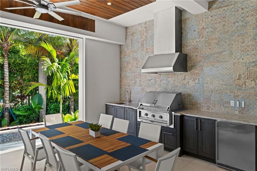 255 21st Avenue South Naples, FL 34102 - Photo 7 of 36 a table and chairs sitting in front of a door