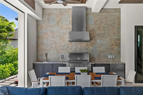 a dining room with furniture and a potted plant