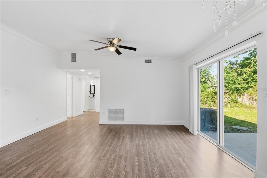 5601 Meridian Way Orlando, FL 32808 - Photo 11 of 34 a view of empty room with wooden floor and fan