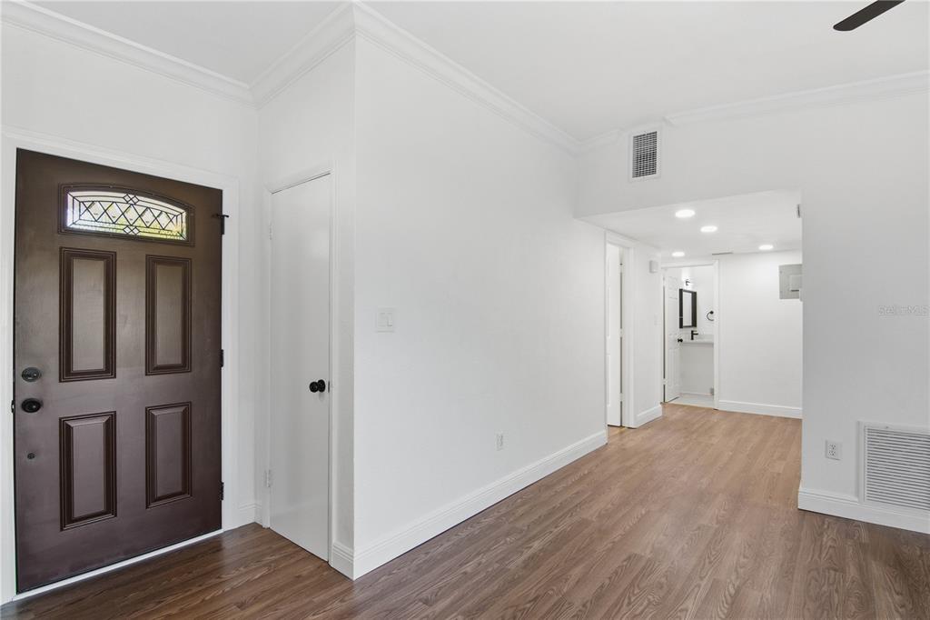 5601 Meridian Way Orlando, FL 32808 - Photo 14 of 34 a view of a hallway with wooden floor