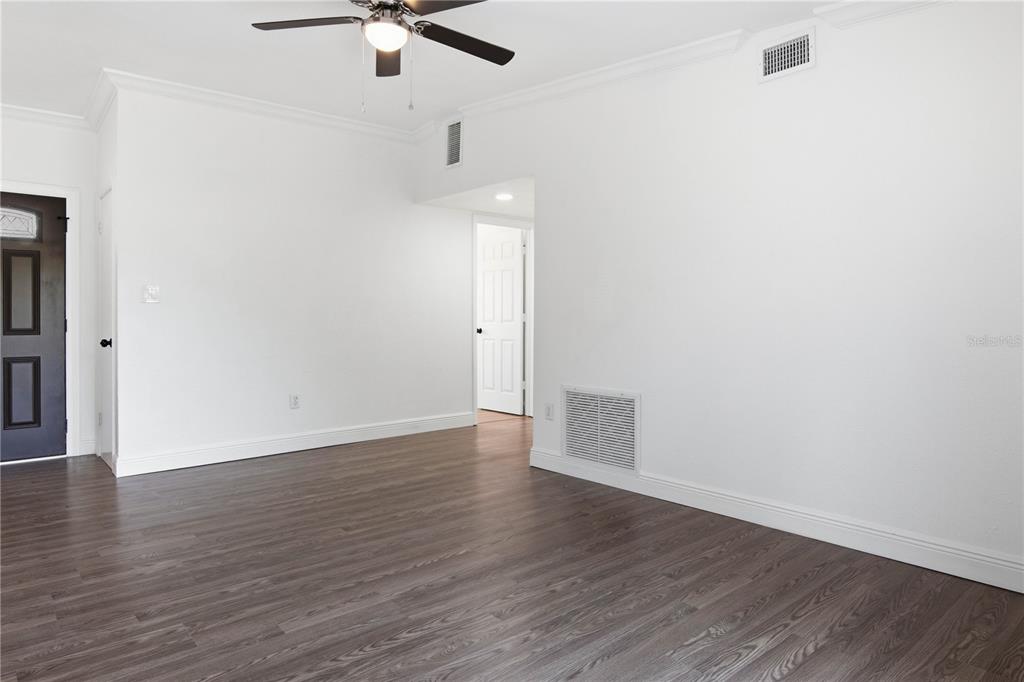 5601 Meridian Way Orlando, FL 32808 - Photo 15 of 34 wooden floor in an empty room