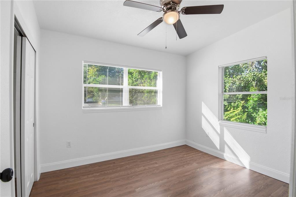 5601 Meridian Way Orlando, FL 32808 - Photo 18 of 34 a view of an empty room with wooden floor and window