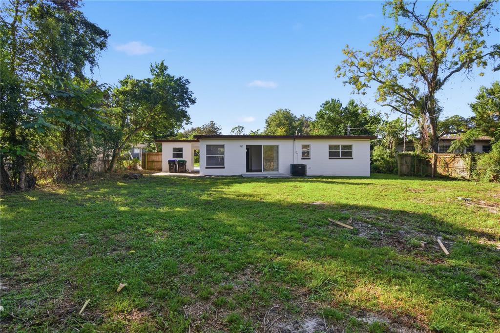 5601 Meridian Way Orlando, FL 32808 - Photo 29 of 34 a view of house with yard and green space
